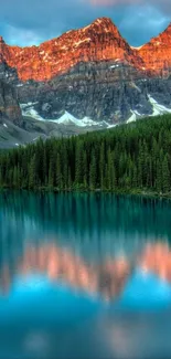 Vibrant sunset over tranquil mountain lake with reflections.