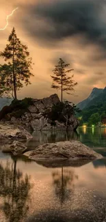 Sunset over mountain lake with reflections, trees and cloudy sky.