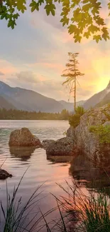 Scenic view of a mountain lake at sunset with vibrant sky and tranquil water reflections.