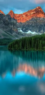 Serene mountain lake reflecting vibrant sunset hues and lush forests.