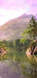 Tranquil mountain lake with pink sky and lush greenery.