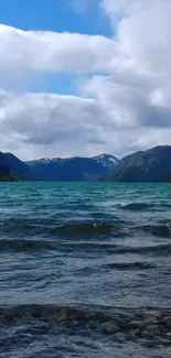 Serene mountain lake wallpaper with blue water and cloudy sky.