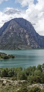 Scenic view of mountain and lake with lush greenery.