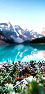 Turquoise blue lake with mountain view and clear sky.