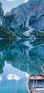 Serene mountain lake with boats and reflective waters under clear skies.