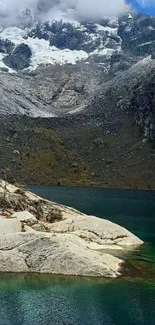 Serene mountain lake with snowy peaks.