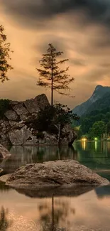 Serene lake at sunset with mountains and lush trees creating a tranquil scene.