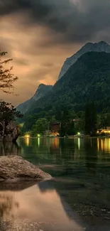 Serene lake with mountains and sunset sky.