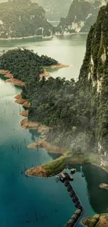 Aerial view of a serene mountain lake surrounded by lush greenery and cliffs.