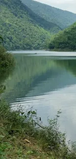 Serene lake with lush green mountains and reflections.