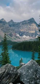 Serene mountain landscape with turquoise lake and pine trees.