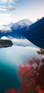 Serene mountain lake with reflections and vibrant foliage.