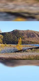 Serene autumn landscape with mountain and lake.