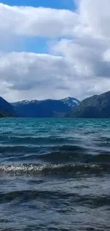 Mountain lake with waves under a blue sky.