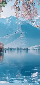 Serene mountain lake with spring blossoms and clear blue water.