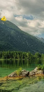 Scenic view of a serene mountain lake with lush greenery and clear skies.