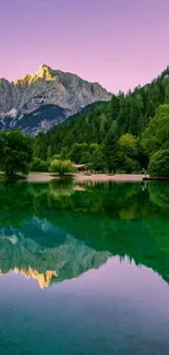 Serene mountain landscape with purple sky reflecting on a calm lake.