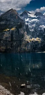 Serene mountain lake with dramatic cliffs under a vibrant blue sky.