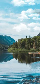 Serene lake with mountains and forest reflecting in the clear blue water.