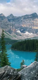 Serene mountain lake with pine trees and rugged cliffs in the background.