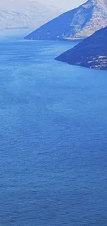 Serene mountain lake with blue water and dramatic peaks.