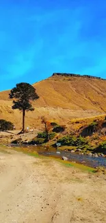 Serene mountain landscape with blue sky and river.