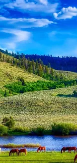 Mountain landscape with green hills, river, and horses under a bright blue sky.