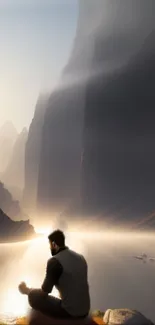 Man meditating by a serene mountain lake at sunrise.