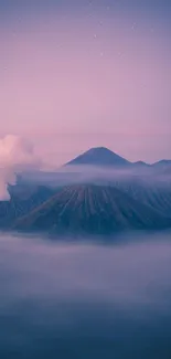 Misty mountains under a serene twilight sky wallpaper.