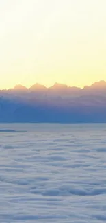 Tranquil dawn view of mountains and misty clouds.