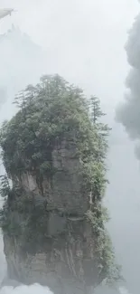 Misty mountain summit surrounded by clouds and a distant airship.