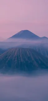 Serene mountain landscape with mist and soft purple hues.