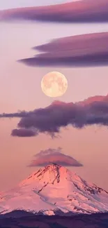 Snowy mountain under a full moon with pink clouds at dusk.