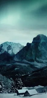 Snow-covered cabin beneath teal night sky in mountain scenery.