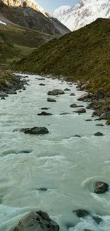 A serene mountain river flows through a lush green valley with snow-capped peaks.