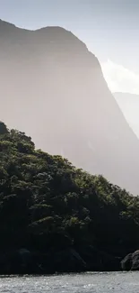 Serene mountain landscape with green forest and calm river.