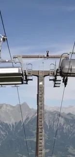 Ski lift overlooking majestic mountain range.