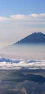 Mountain and sky wallpaper with misty clouds.