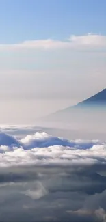 Tranquil mountain peak with clouds and blue sky wallpaper.