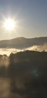 Serene sunrise over misty mountains with golden sunlight.