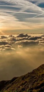 Serene sunrise over mountains with clouds and golden light.