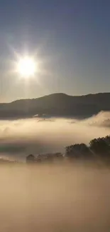 Sunrise over misty hills with clear blue sky