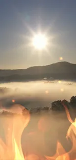 Peaceful mountain sunrise with mist and fire accents in the foreground.