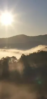 Serene sunrise over misty mountains with golden light illuminating the valley.