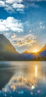 Sunset over mountains with lake reflection, under an azure blue sky.