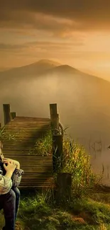 Girl sitting on dock at sunset with mountains in the background.