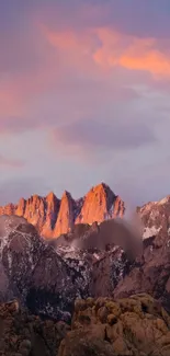 Serene sunset over mountains with a colorful sky and rocky peaks in view.