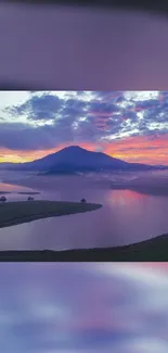 Serene mountain sunset with a lake reflecting vibrant colors.