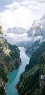 Breathtaking view of a mountain valley with a river winding through lush greenery.