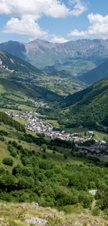 A serene mountain valley with green hills and a picturesque village under a blue sky.